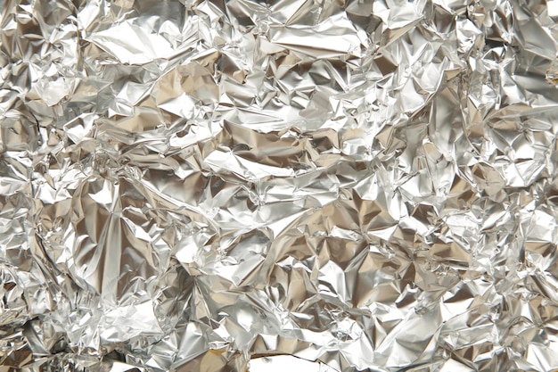 Texture of crumpled aluminium foil Space for text