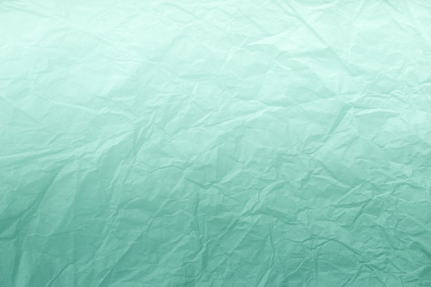 Texture of crumpled green wrapping paper with white gradient