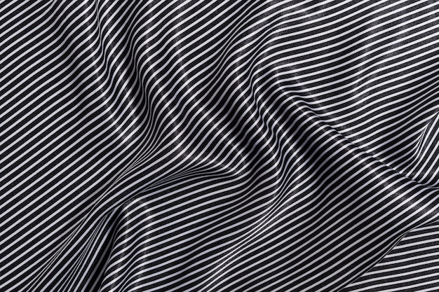 texture of crumpled wrinkled silk fabric of white and black striped color the concept of materials for sewing clothes and a marine theme Image for your design