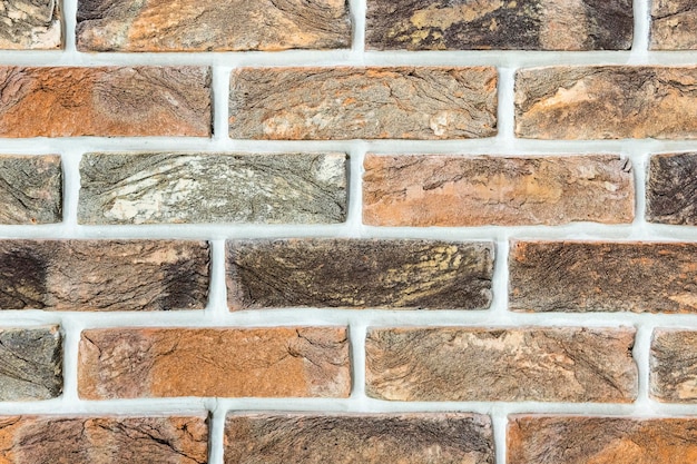 Texture of a decorative brick wall with cracks as a background