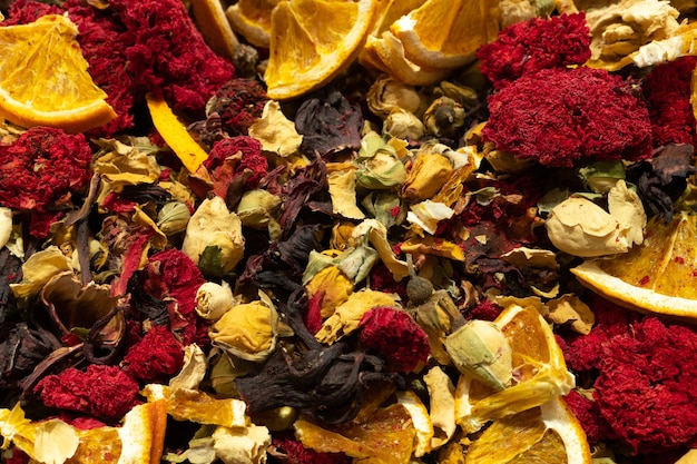 Texture of dry herbal tea with spices and fruits hibiscus orange star anise flowers