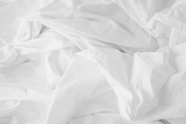 Photo texture of fabric is white color background,wavy folds of cloth.