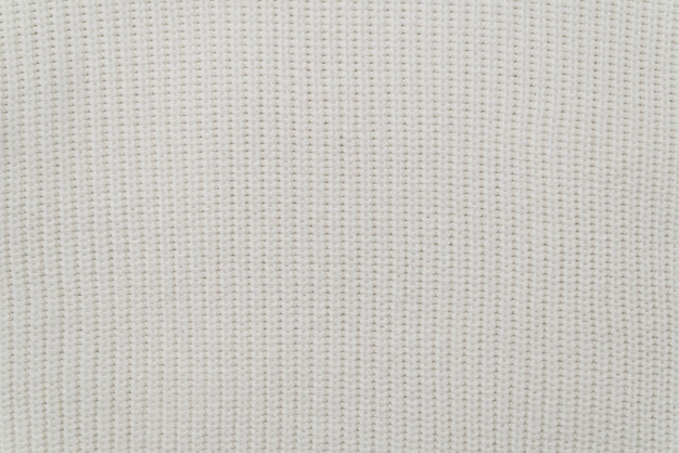 Photo texture of the fabric of a warm white sweater