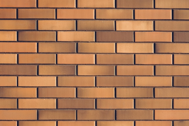 Texture of a fence of orange clay bricks