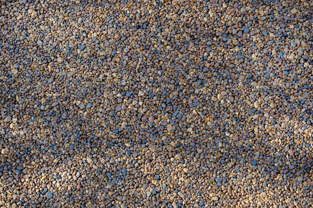 Texture of flashing pebbles background, stone pavement.