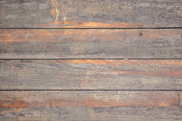 Texture from old wooden boards with traces of wiped orange paint