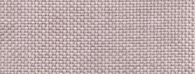 Photo texture gray background from woven textile material with wicker pattern macro vintage ivory fabric