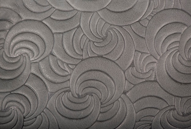 Photo texture of gray genuine leather with embossed floral trend pattern closeup color for wallpaper or banner design fashionable modern background