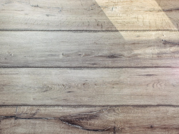 Texture of gray wood floor lit by sun