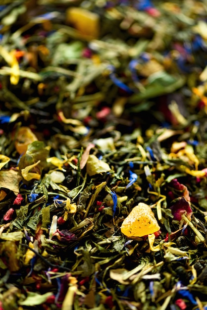 Texture of green tea with dried petals of blue flowers, calendula, cornflower. Food. Organic healthy herbal leaves, detox tea.