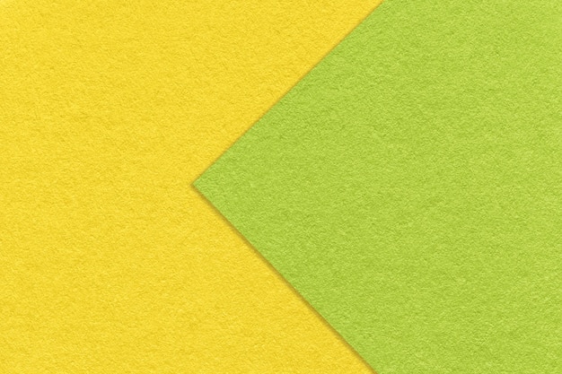 Texture of green and yellow paper background half two colors macro Structure of dense craft cardboard