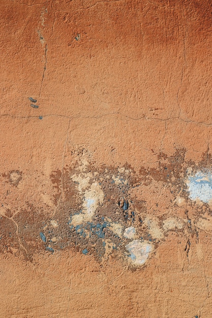 Strutturi il fondo di lerciume del muro di pietra concreto con la pittura della sbucciatura