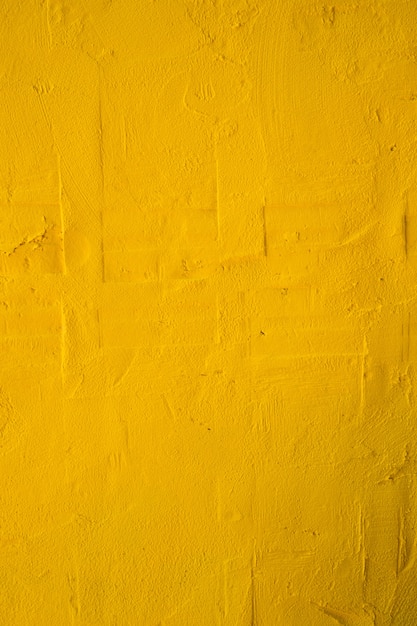 Photo texture of grungy old yellow concrete background