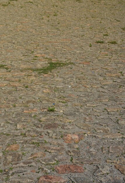 Photo the texture is very old and inaccurately laid out pavers made of relief stones of various shapes