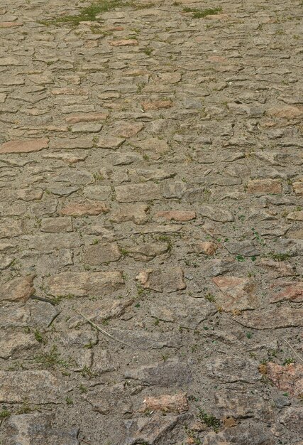 Photo the texture is very old and inaccurately laid out pavers made of relief stones of various shapes