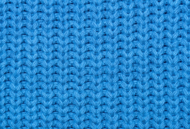 The texture of the knitted fabric in blue. 