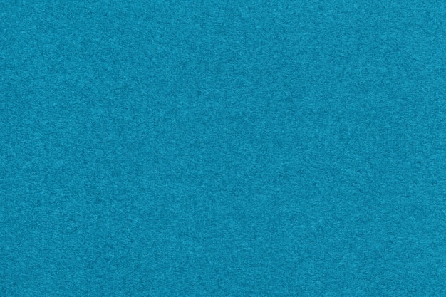 Texture of light blue and turquoise colors paper background\
macro structure of dense craft cerulean cardboard