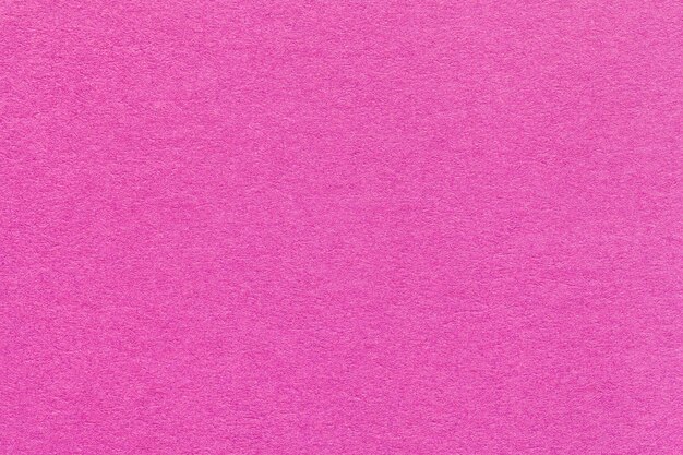 Texture of light purple and lilac colors paper background macro Structure of dense magenta craft cardboard