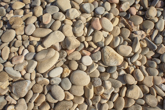 Texture of light stones of different shapes and sizes typical of the southern coast of Sardinia 

