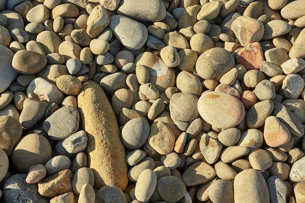 Texture of light stones of different shapes and sizes typical of the southern coast of Sardinia 

