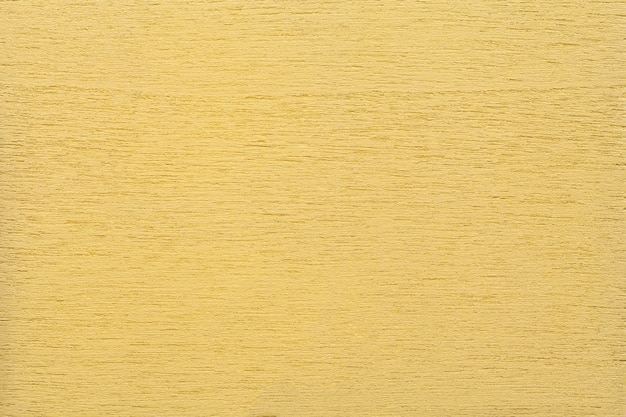 Texture of light yellow clean woody background, closeup  Structure of the painted wood