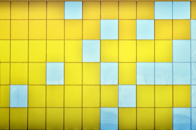 the texture of the metal wall, framed in the form of colored squares of two colors.