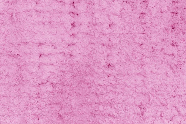 Фото Текстура розовой штукатурки. шероховатая стена здания.