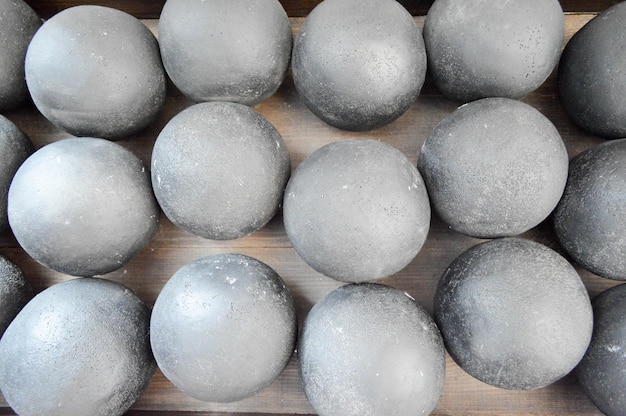 Texture of old antique combat round gray metallic iron stone cannon balls ammunition The background