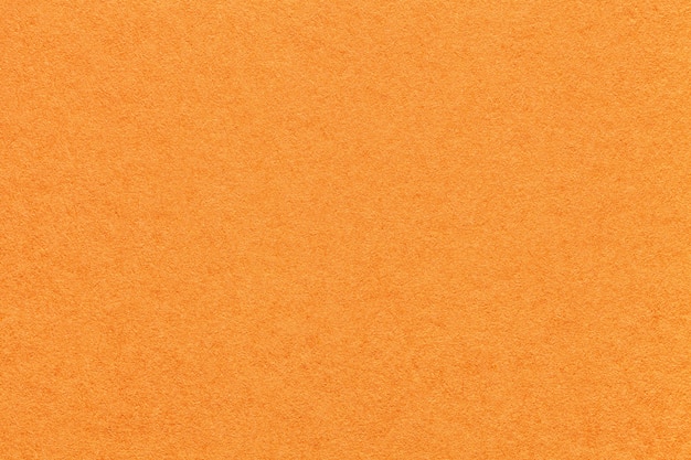 Texture of old bright orange paper background,  Structure of dense carrot cardboard