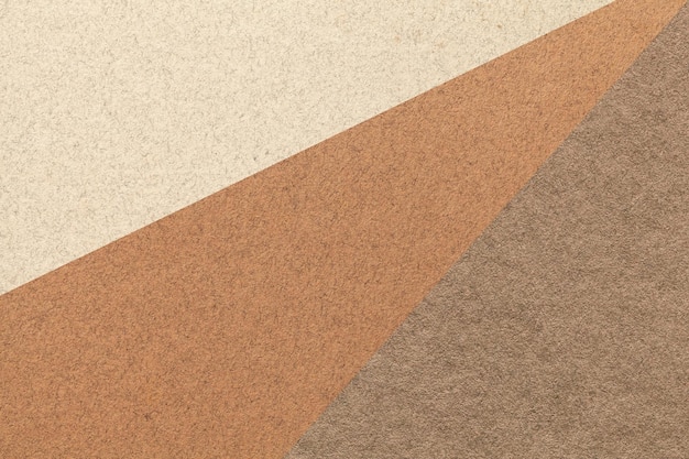 Texture of old craft beige brown and umber color paper background macro Structure of vintage abstract cardboard