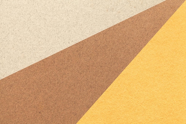 Texture of old craft beige brown and yellow color paper background macro Vintage abstract cardboard