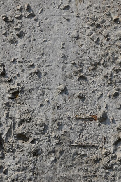 Texture of the old embossed concrete wall in gray color. Background image of a concrete product