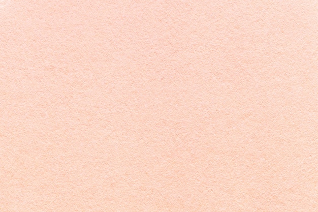 Texture of old light pink paper background,  Structure of dense coral cardboard