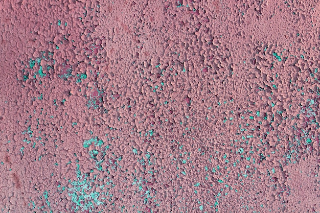 Texture of old pink cracked paint on wall.