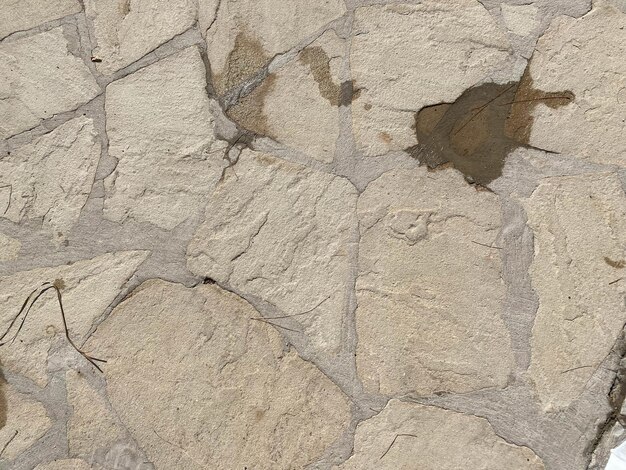 Texture of old stones of various forms with seams Close up of shabby masonry Stone wall from uneven