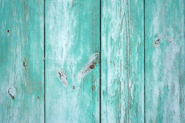 Texture of old wood rustic background with peeling light green paint. Horizontal.