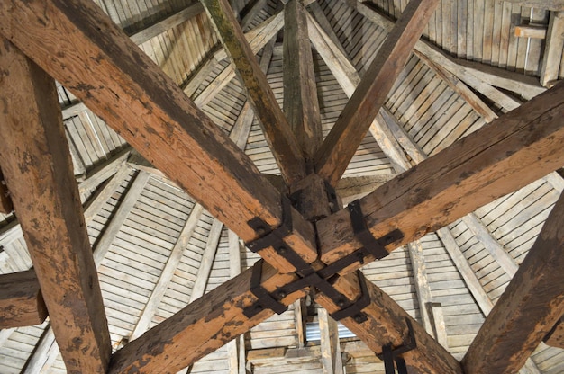 The texture of the old wooden ancient fat people strong beams log and ceilings under the ceiling