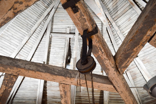 古い木製の古代の厚く丈夫な梁のラグと天井と荷重持ち上げ機構の質感