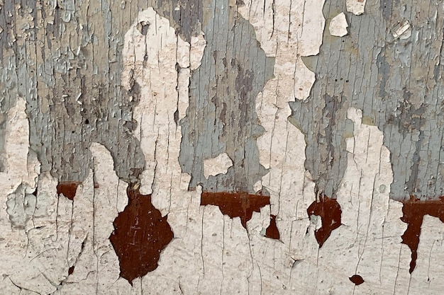 Photo texture of old wooden wall with cracking white paint