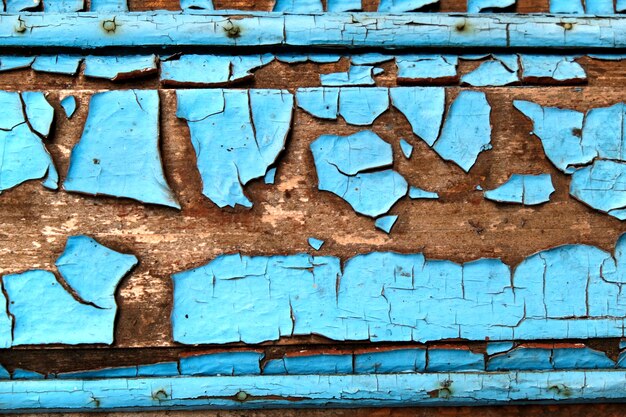 Texture di un vecchio muro di legno con sfondo astratto di vernice blu pelati.