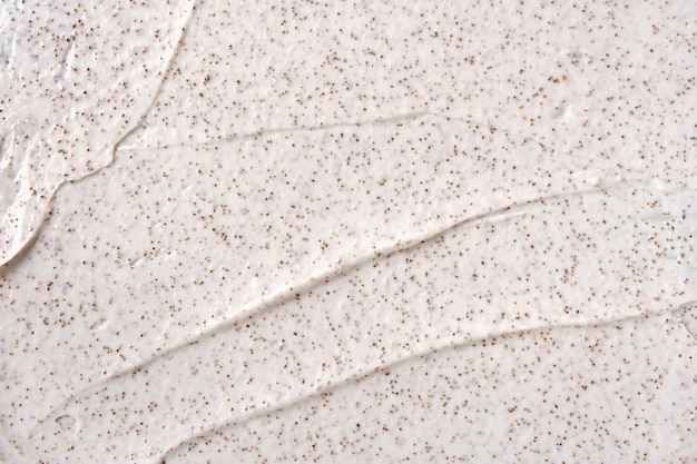 Texture of organic white scrub with Exfoliating coffee particles Closeup