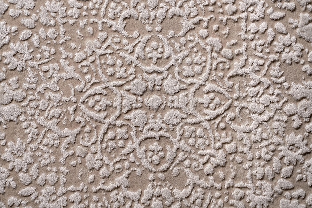 Texture of ornate decorative velours carpet fabric pattern