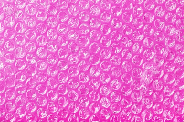 The texture of the packaging airbubble film on a Pink background in full screen