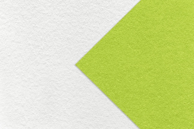 Texture of paper white background half two colors with green arrow macro Structure of dense craft olive cardboard