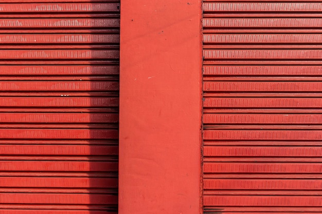 Texture pattern of iron door of closed store and rough wall in brazil