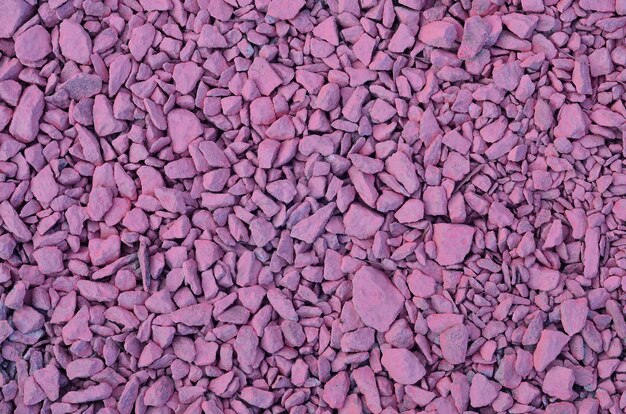 Texture of a pile of crushed stones, painted in pink