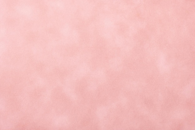 Texture of pink old paper, crumpled background. Vintage rose grunge surface. Matt velvet textile backdrop.