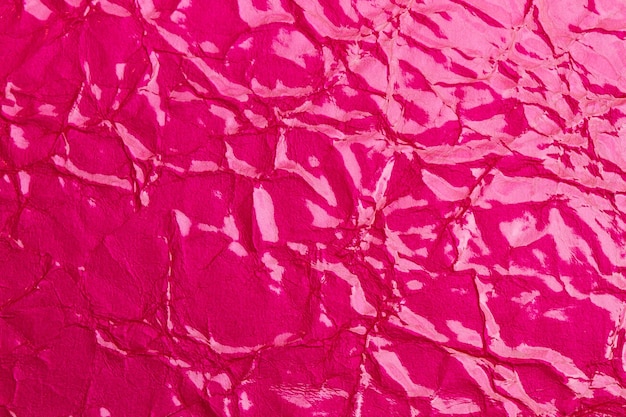 Texture of a pink wrinkled cloth in a close up view