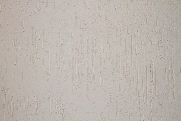 The texture of a plaster or wall with small indentations