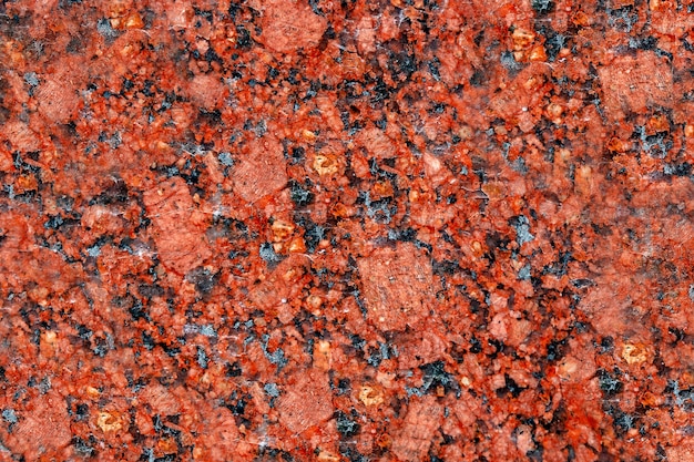 Texture of polished red granite stone. Abstract background